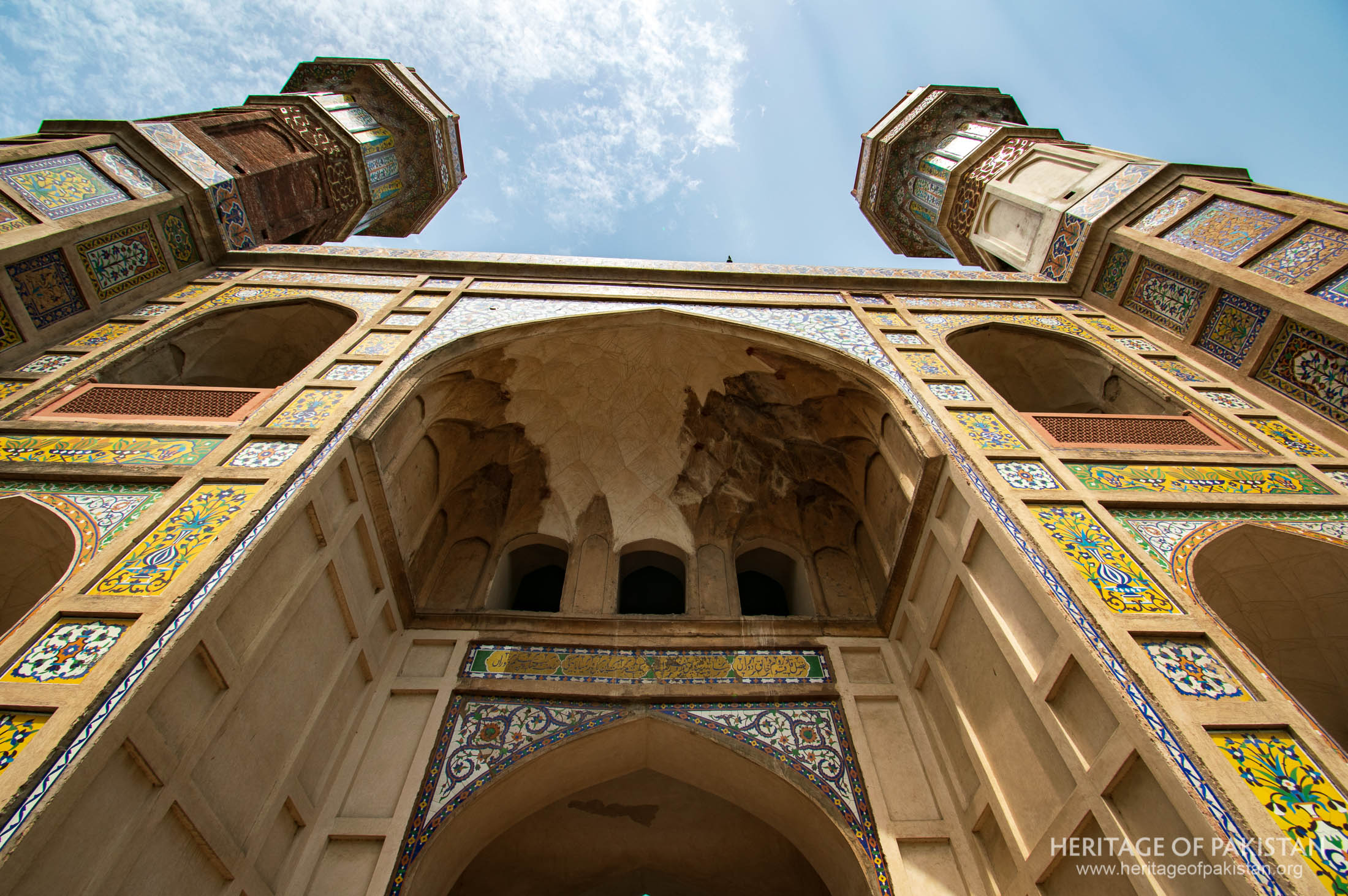 The structure showcases Mughal, Timurid, and Persian influences with vibrant Kashikari tilework.